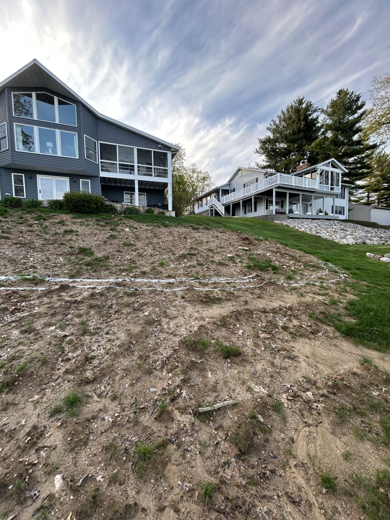 Before: bare dirt slope between two homes
